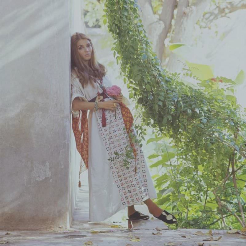 Talitha Getty leaning on a wall with vines by her house in Marrakesh, Morocco, January 15, 1970