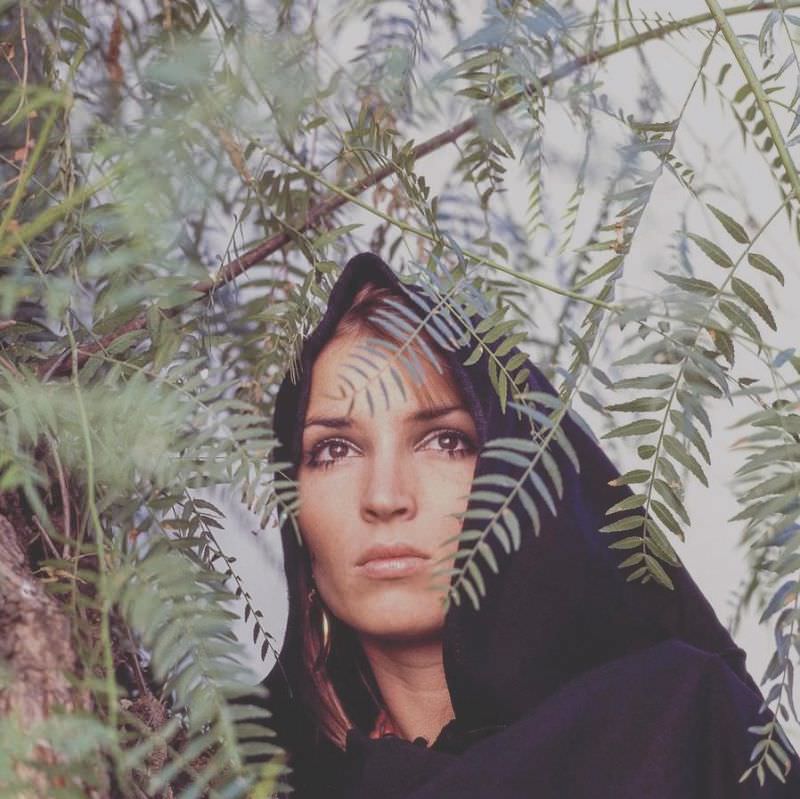 Talitha Getty wearing a headscarf behind ferns in Marrakesh, Morocco, January 15, 1970