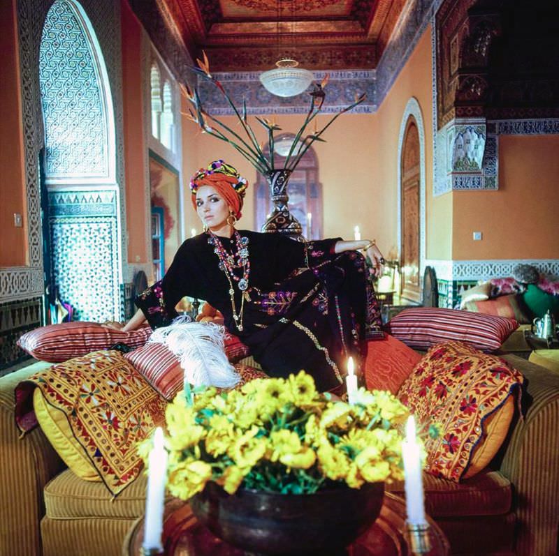 Talitha Getty wearing a turban and kaftan in her living room in Marrakesh, Morocco, January 15, 1970