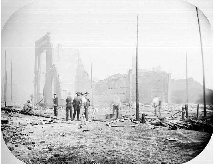 Group of men examining the ruins, 1889