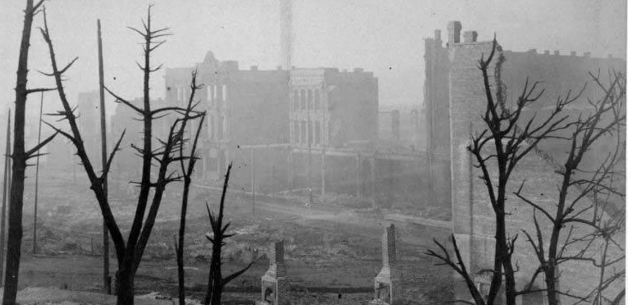 The ruins along Front St. including the Merchants National Bank, 1889