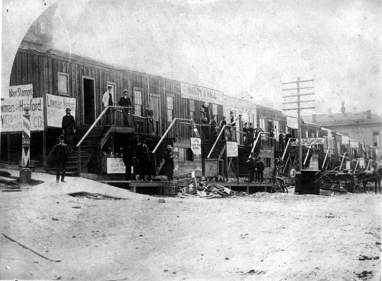 Businesses at the corner of 3rd Ave. and James St, 1889