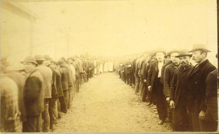 Bread line at the tent of the Tacoma Relief Bureau in vicinity of 3rd Ave. near Union St., Washington, 1889