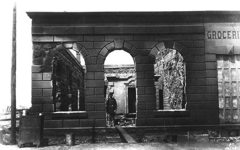 Remains of Dexter Horton & Co. bank, 1st Ave. S. and S. Washington St., with John B. Denny of the Washington National Guard on duty, 1889