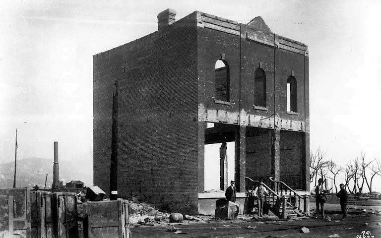 Ruins of Dearborn Block, 322 1st Ave. S., with John B. Denny of Washington National Guard on duty, 1889