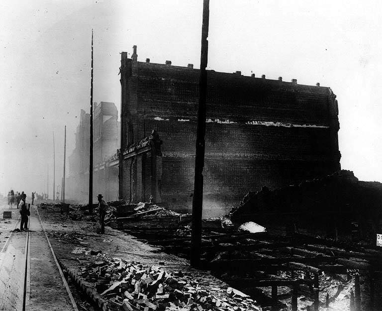 Walls of burned building at right; cable car tracks at left, 1889