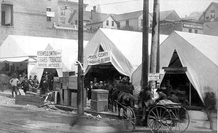 Businesses housed in tents and street traffic, 1889