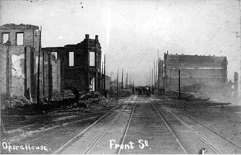Looking south past the ruins of the Frye Opera House on Front St. near Madison St, 1889