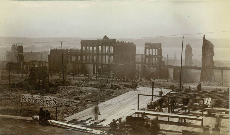 The walls standing were those of brick buildings on First Avenue, west side, between Yesler Way and Columbia Street.