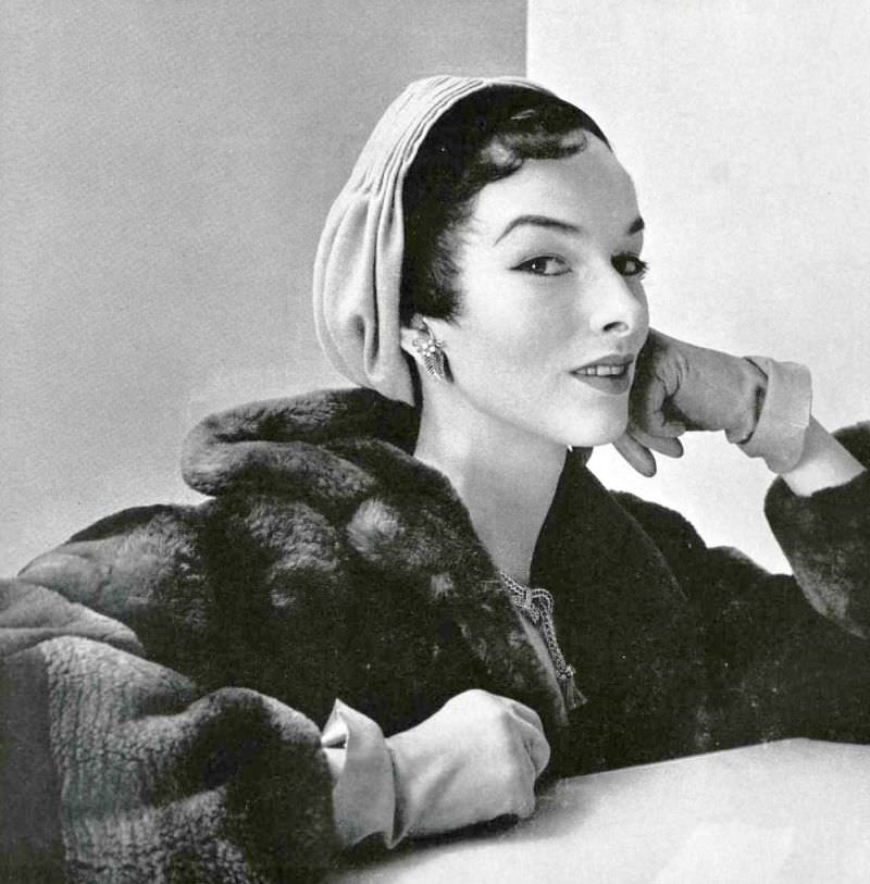 Victoria von Hagen in a velvet and jersey turban by Paulette, beaver coat by Max Réby, jewelry by Mauboussin, L'Officiel, 1953