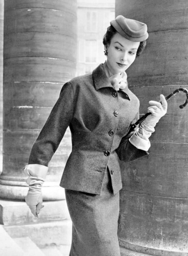 Victoria von Hagen in grey flannel day suit brightened with orange mousseline scarf by Christian Dior, L'Officiel, 1953