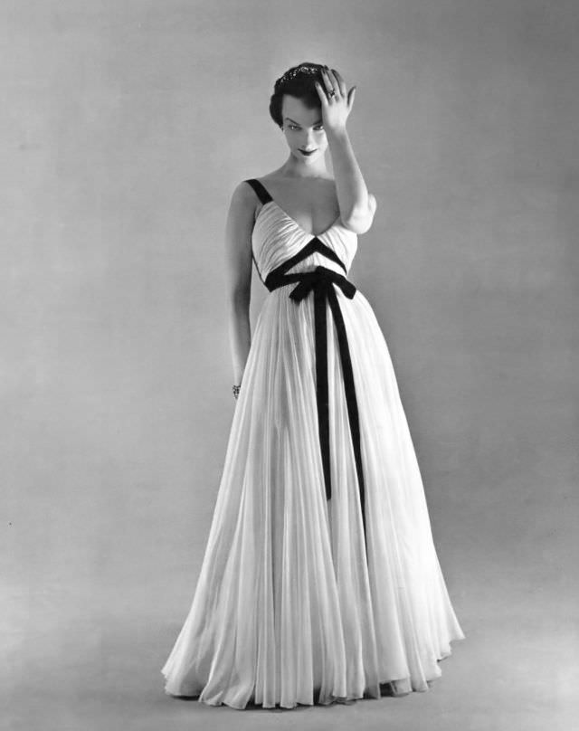 Victoria von Hagen in white mousseline evening dress adorned with black ribbons by Jacques Griffe, L'Officiel, 1953