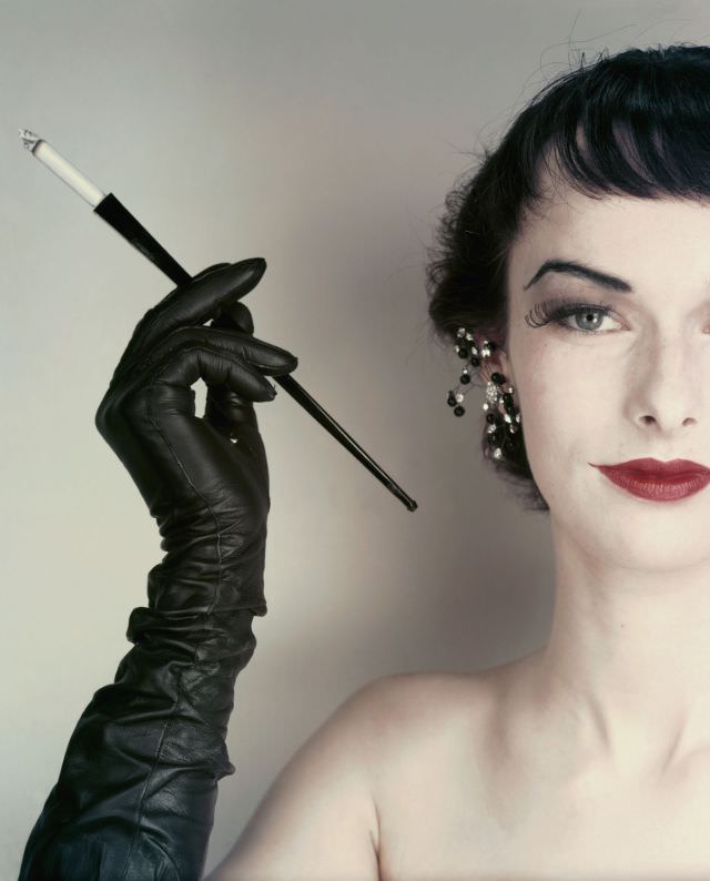 Model Victoria von Hagen wearing jet and glitter earrings, full-length gloves by Super, 1952