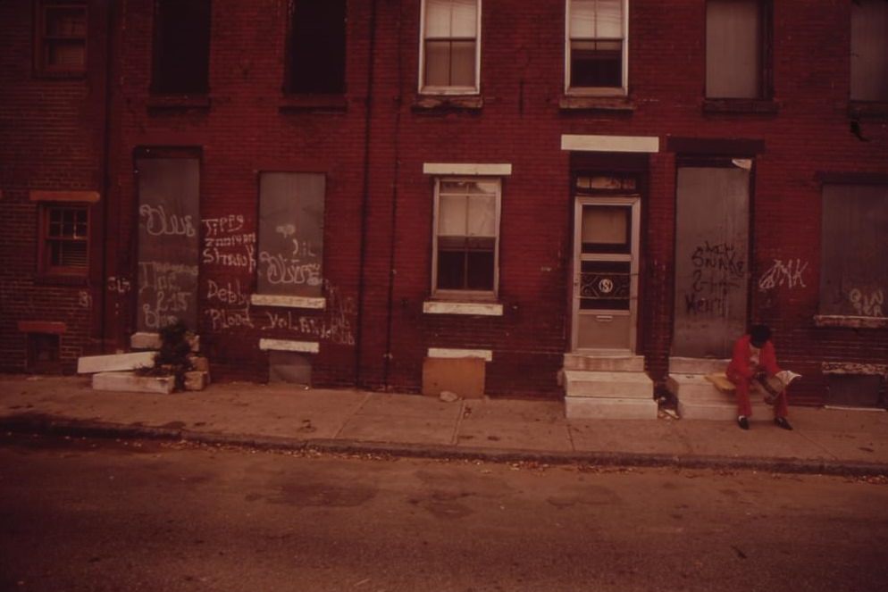 Two Men Sit Silently On Stoops Of Abandoned North Philadelphia Houses, August 1973