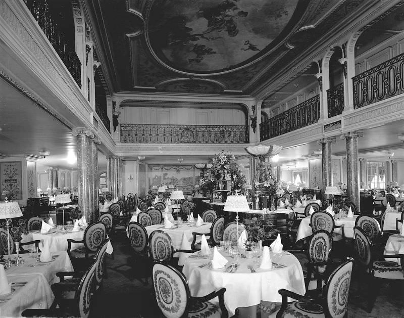 1st Class Dining Saloon aboard Aquitania. The First Class Dining Saloon (Louis XVI Restaurant), on the Upper Deck (D Deck). A view of the central area, looking forward, May 1914