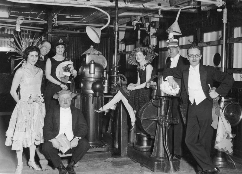 A group of Aquitania passengers pose on the liner's bridge during a Fancy Dress Ball on the night of January 25, 1927