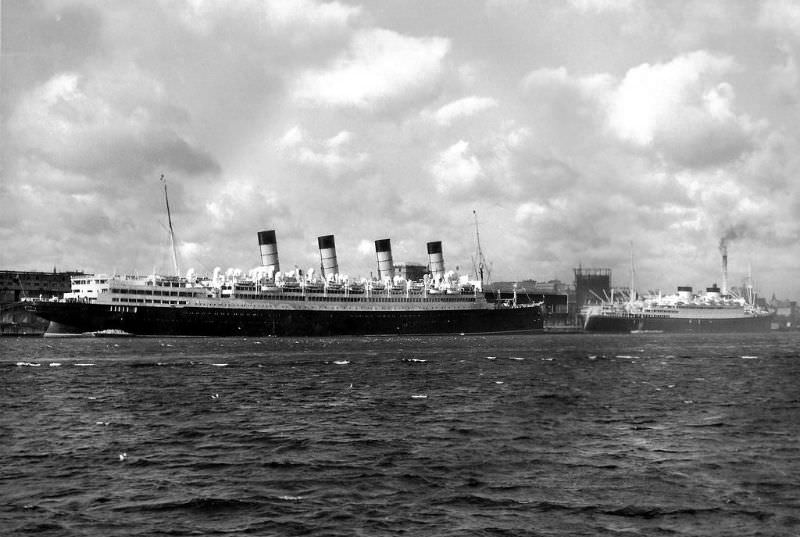 Aquitania and Britannic at Halifax in the summer of 1949. After completing troopship service, Aquitania was handed back to Cunard-White Star in 1948. She underwent a refit for passenger service