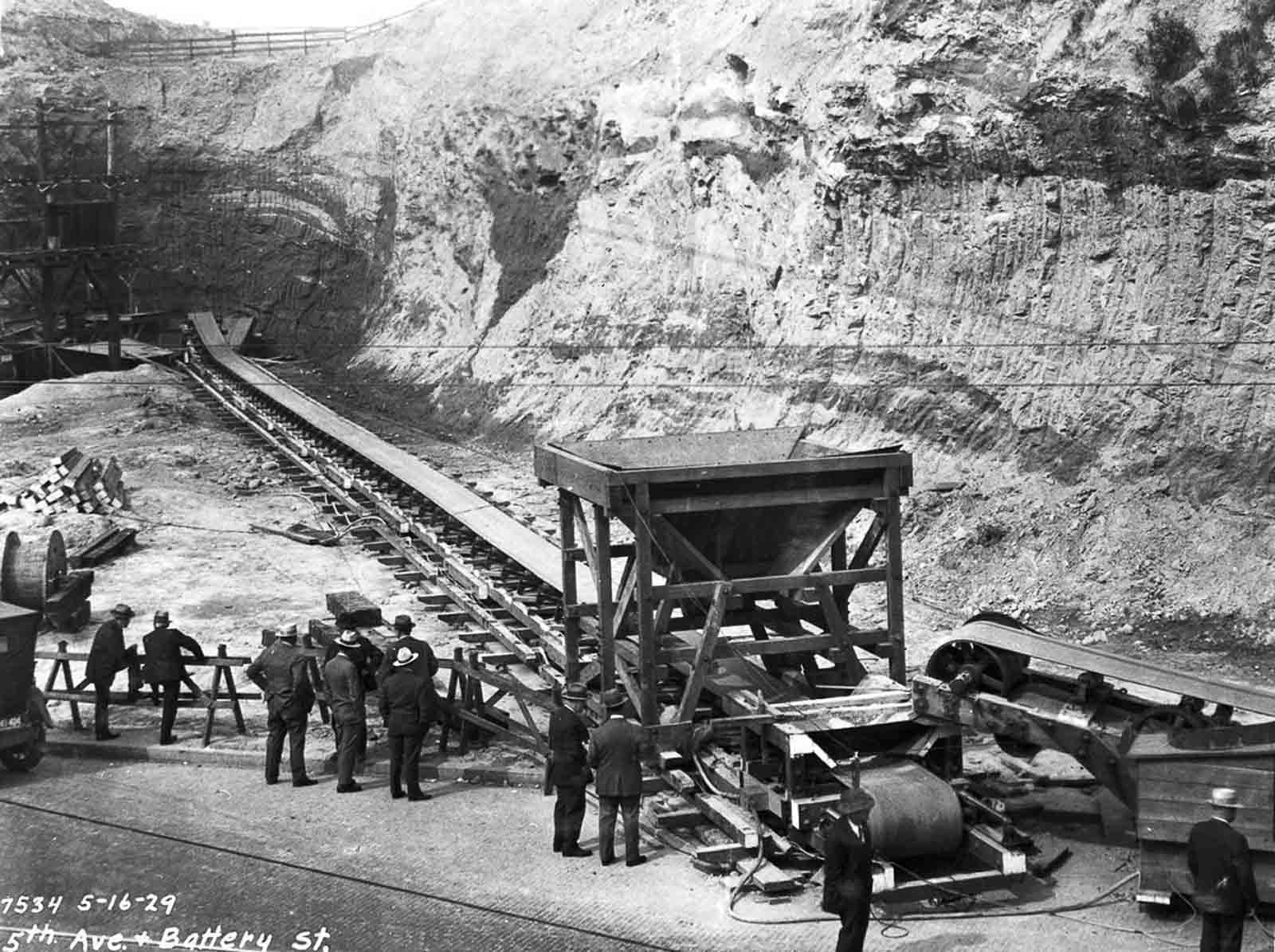 A conveyor belt for moving earth at Fifth Avenue and Battery Street.