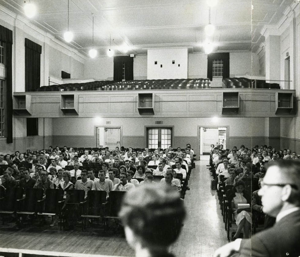The inside of old central high, in the auditorium full of students for graduation, 1980s