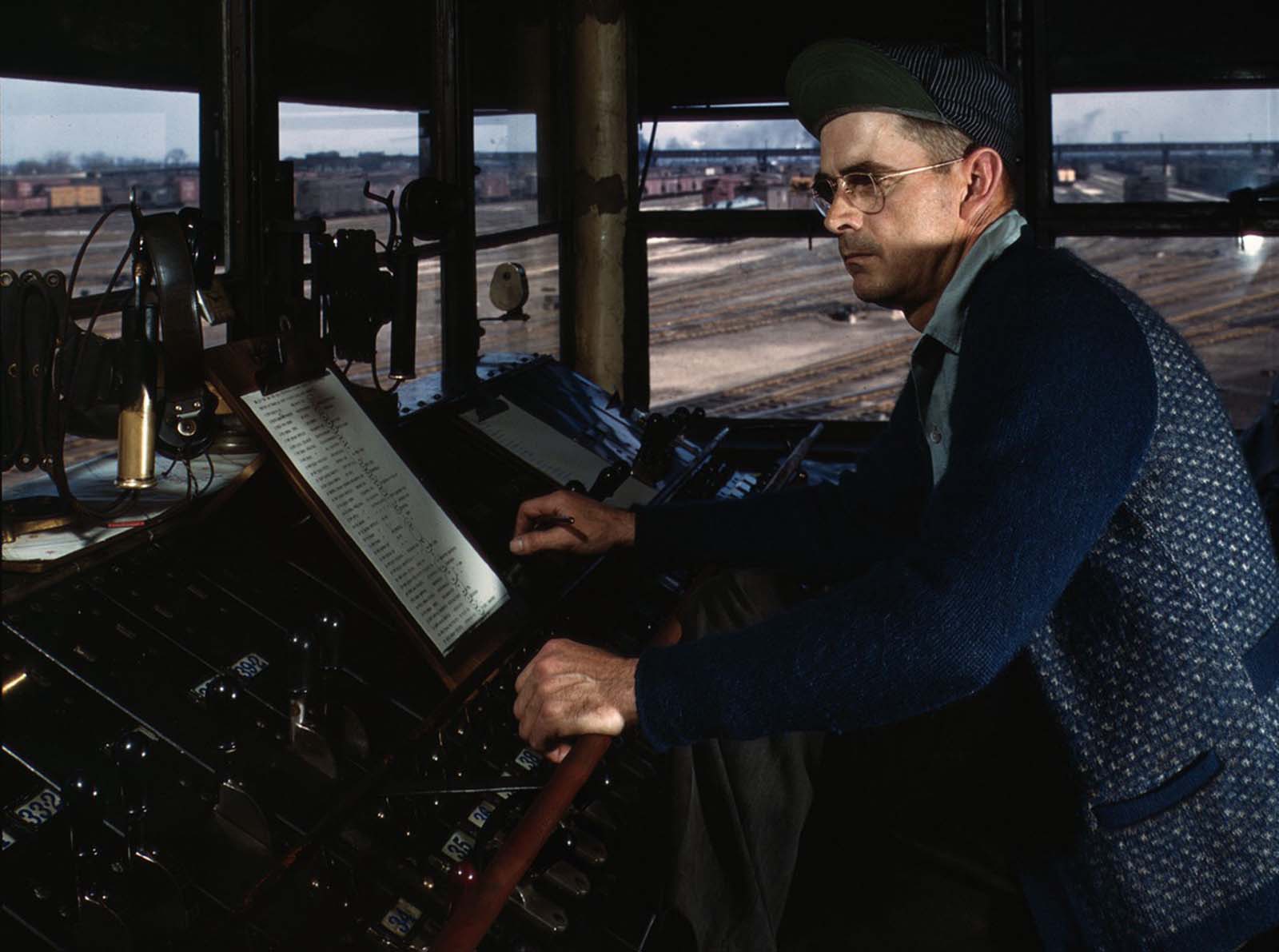 The Chicago and North Western Railroad tower man R. W. Mayberry of Elmhurst, Illinois, at work in the Proviso yard in May 1943.