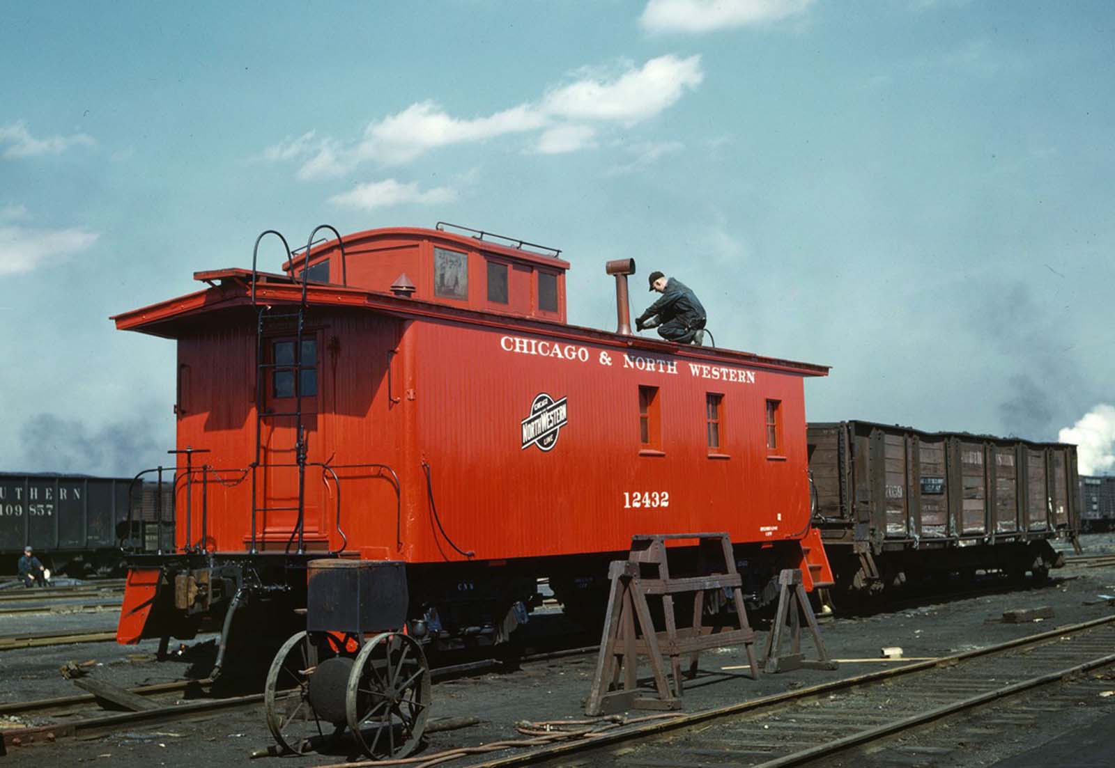 Putting the finishing touches on a rebuilt Chicago and North Western Railroad caboose at the rip tracks in the Proviso yard in Chicago in April 1943.