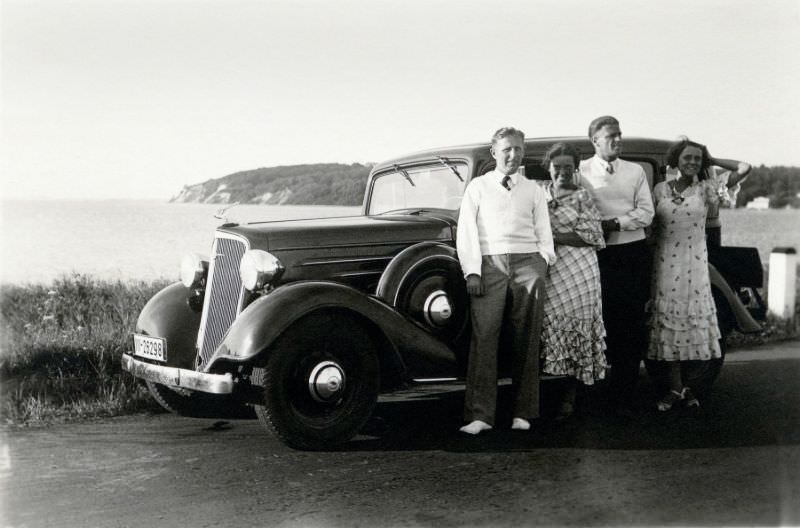 Two stylish couples posing with a 1934 Chevrolet Master Sedan at the seaside on the island of Rügen.