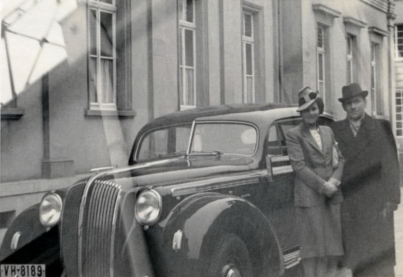 A well-to-do couple posing with an Opel Admiral on a bleak winter's day. The car is registered in the state of Hesse, 1939