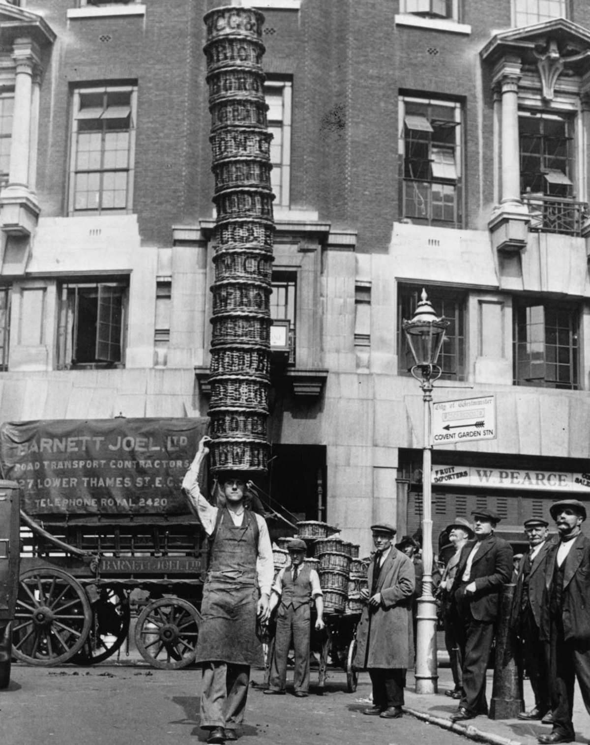 Market trader Alfred Bailey practicing with 15 baskets at Covent Garden, London, for the basket-carrying championships, 1925.