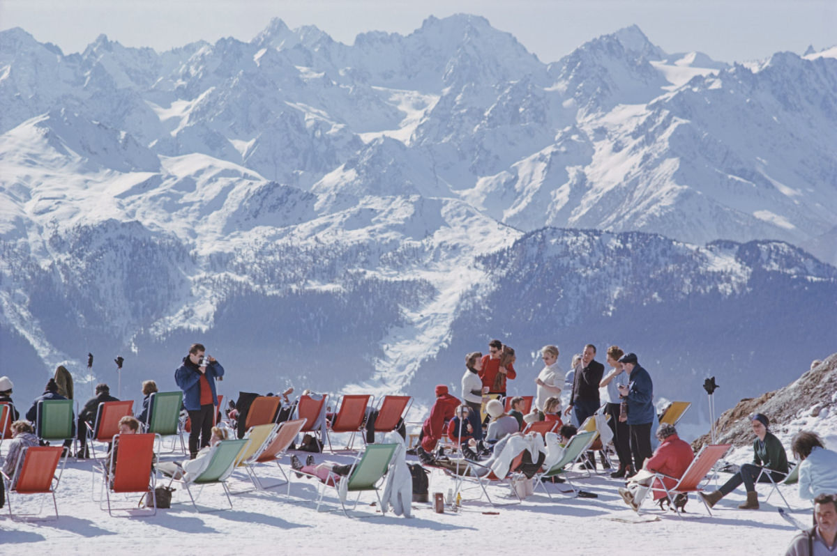 Holidaymakers in sun loungers on the slopes at Verbier, Switzerland, February 1964.