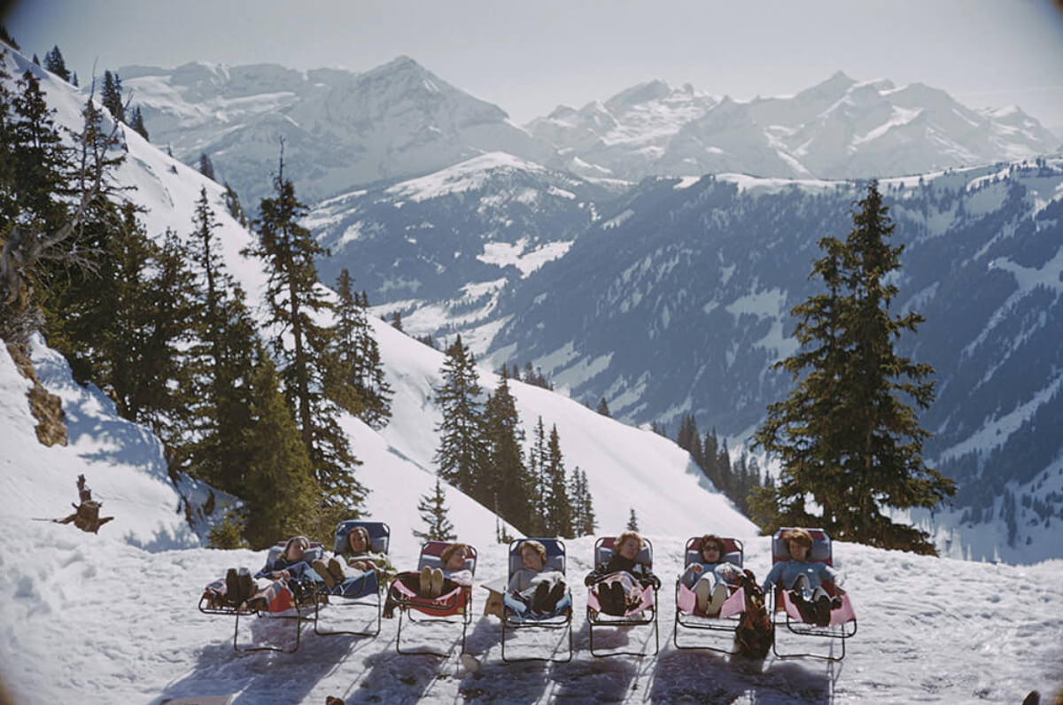 Holidaymakers in sun loungers on the slopes at at Gstaad, Switzerland, March 1961.