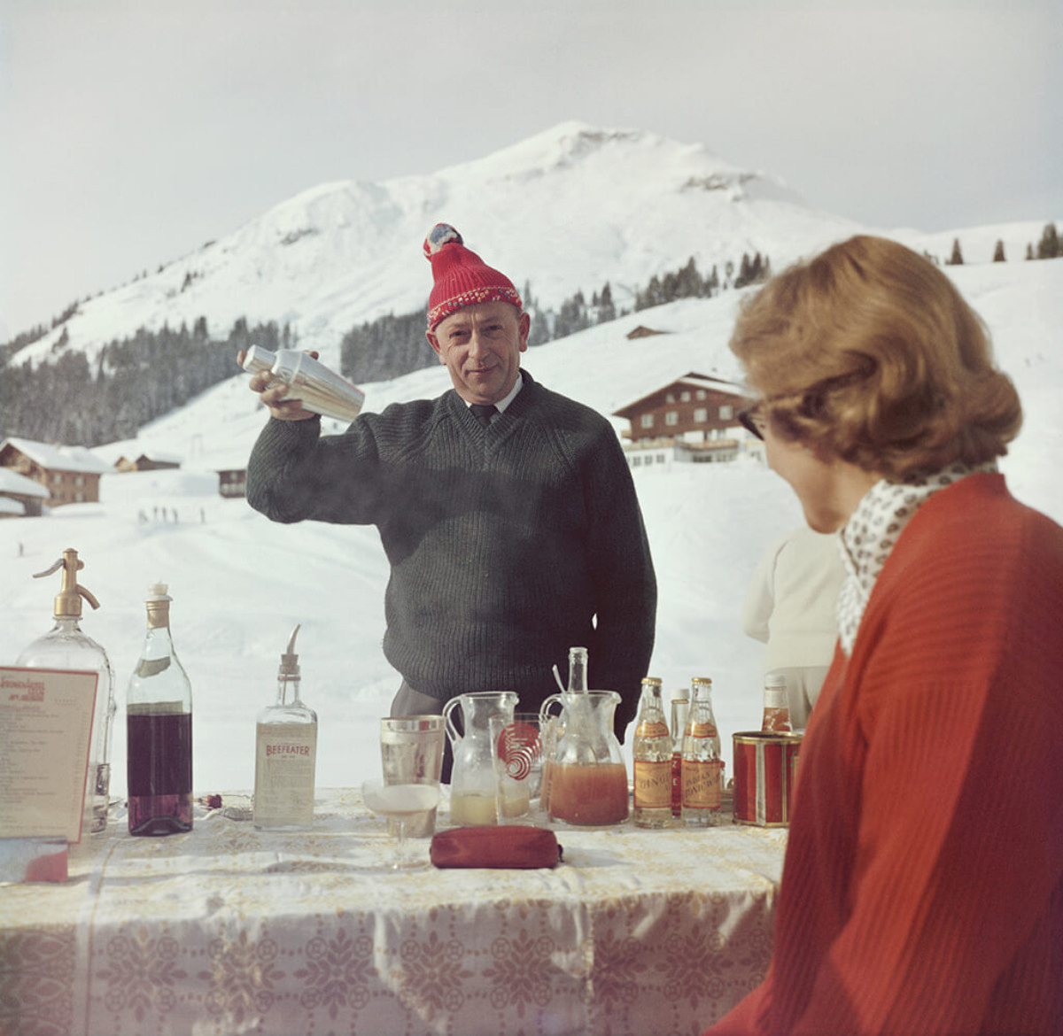 A bartender mixes a drink for a customer at the Ice Bar at the Hotel Krone in Lech, Austria, 1960.