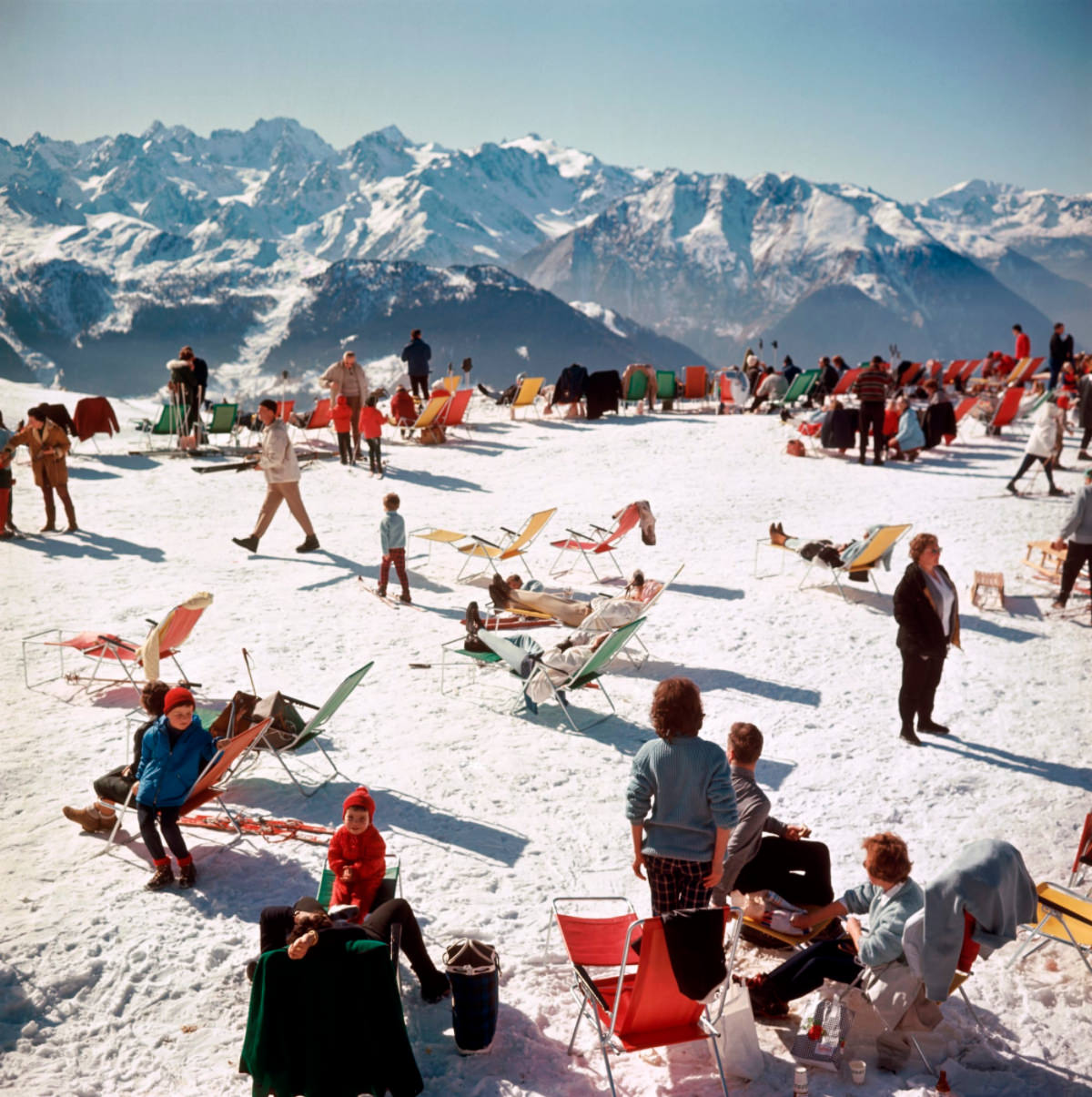 Holiday-makers take the sun on a mountain top in Verbier, 1964.