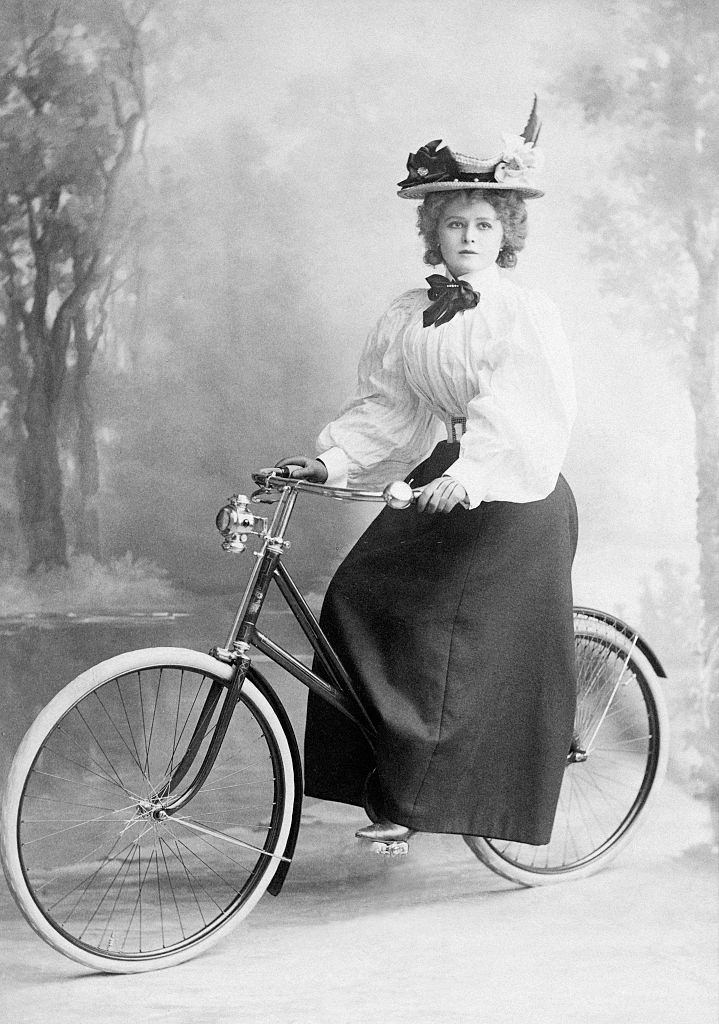 Mabel Love on a bicycle, posing for a photograph, 1905.