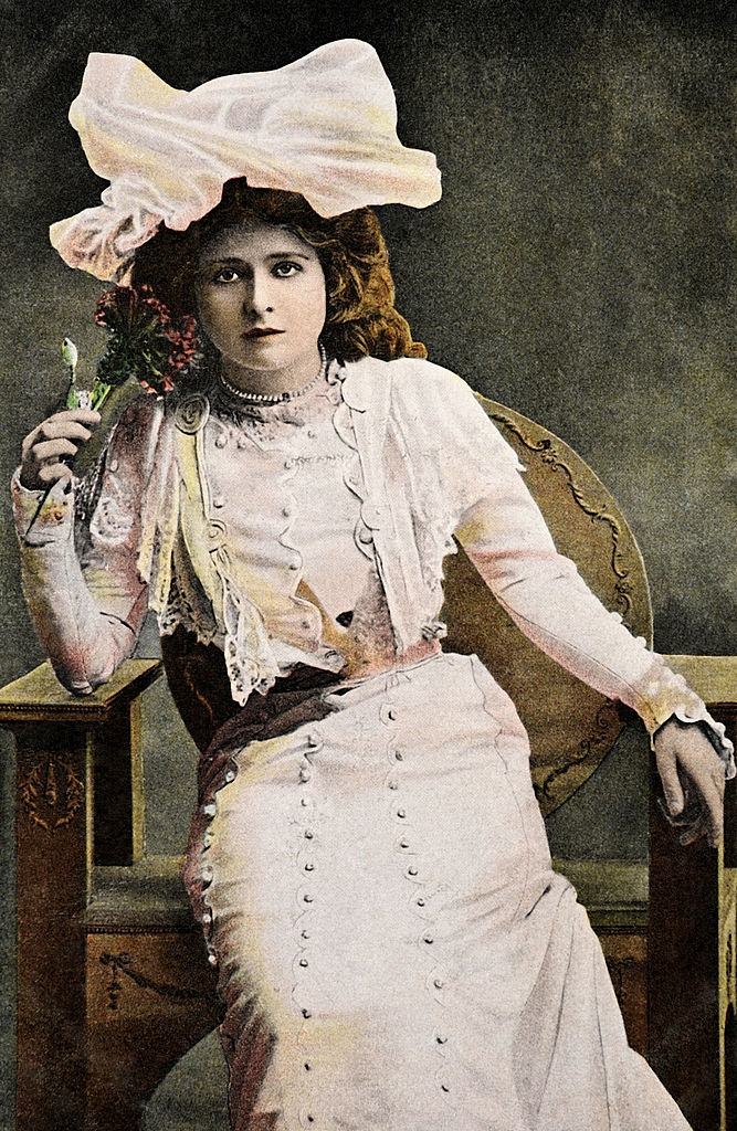 Mabel Love holding a flower, 1910.