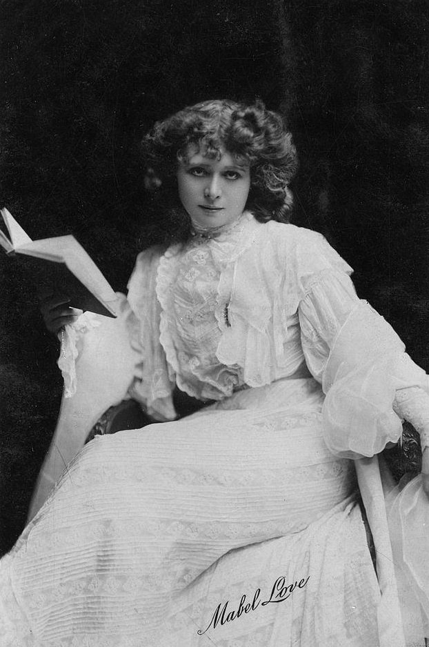 Mabel Love stares intently into the camera for a photo postcard issued early 20th century in London, England.