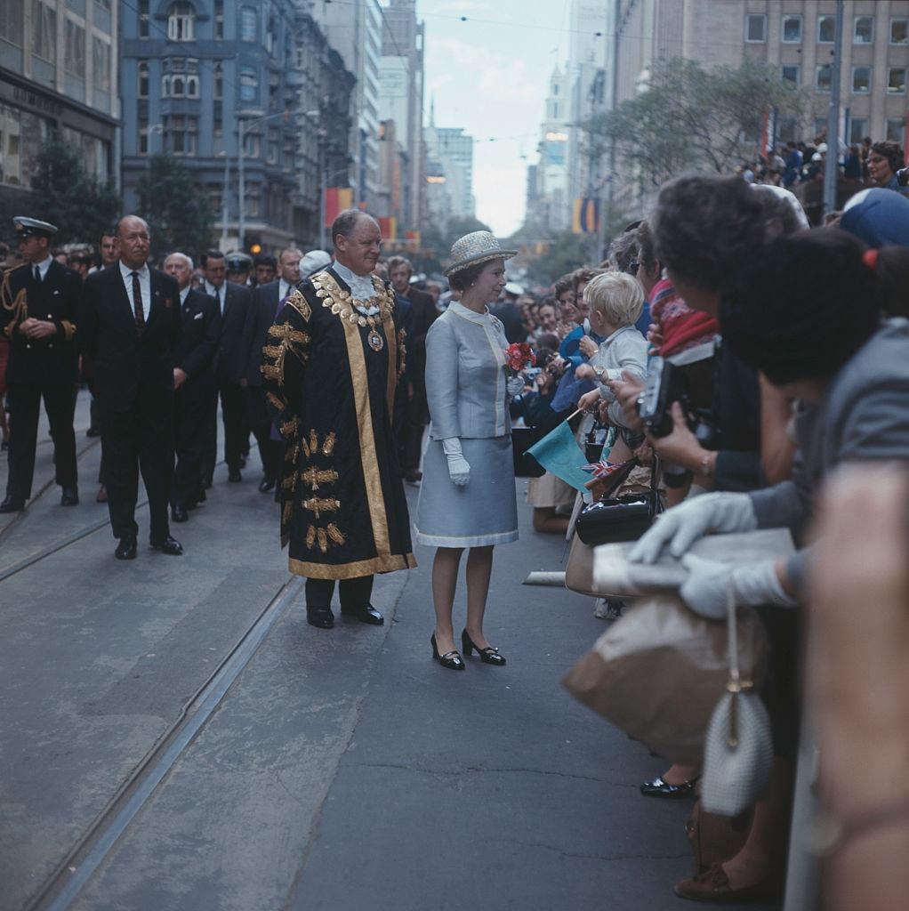 Queen Elizabeth II on a walkabout in Melbourne with Ted Best (1917 - 1992), Lord Mayor of Melbourne, during her tour of Australia, 6th April 1970.