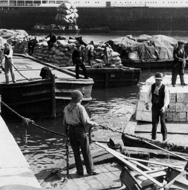 Workers and seamen at a harbour.