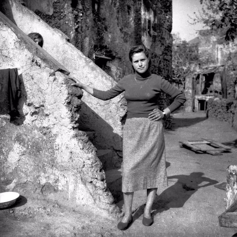 A woman posing near stairs