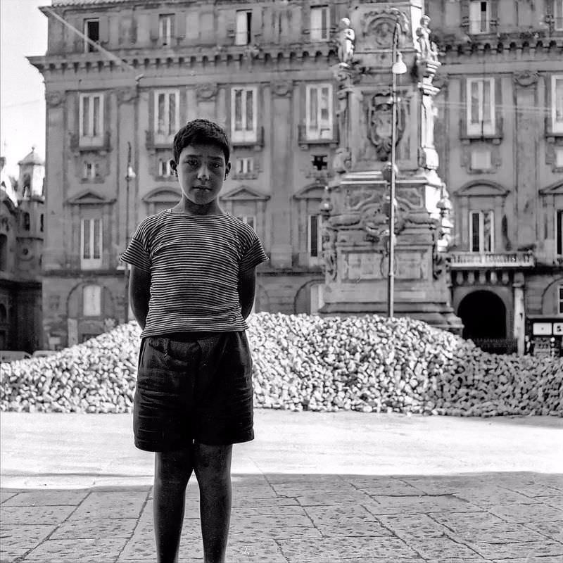 A boy standing near the statue.