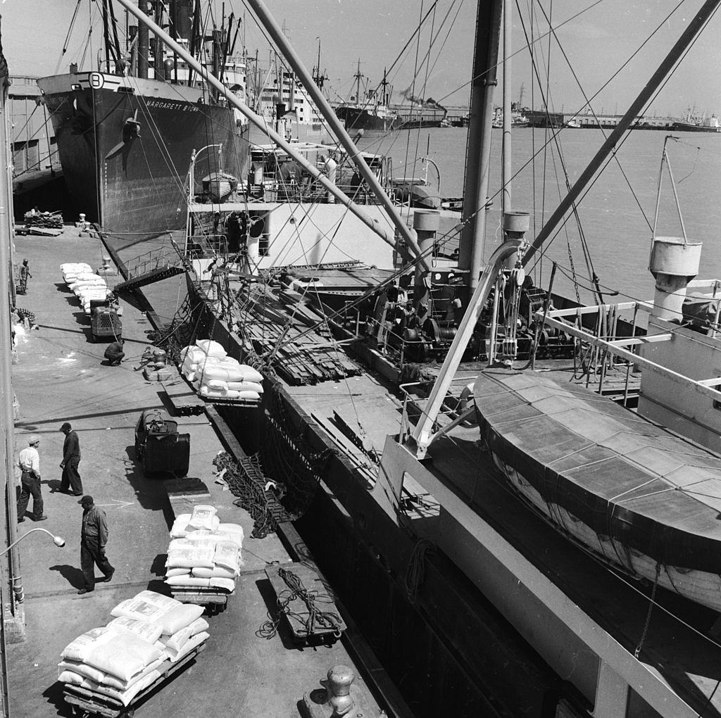 Cargo being loaded onto freight ships in New Orleans dock, 1950.