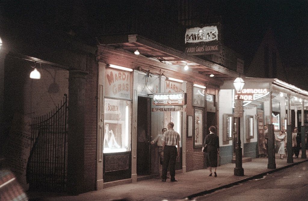 A view down Bourbon street and the Mardi Gras Club in New Orleans, 1957.