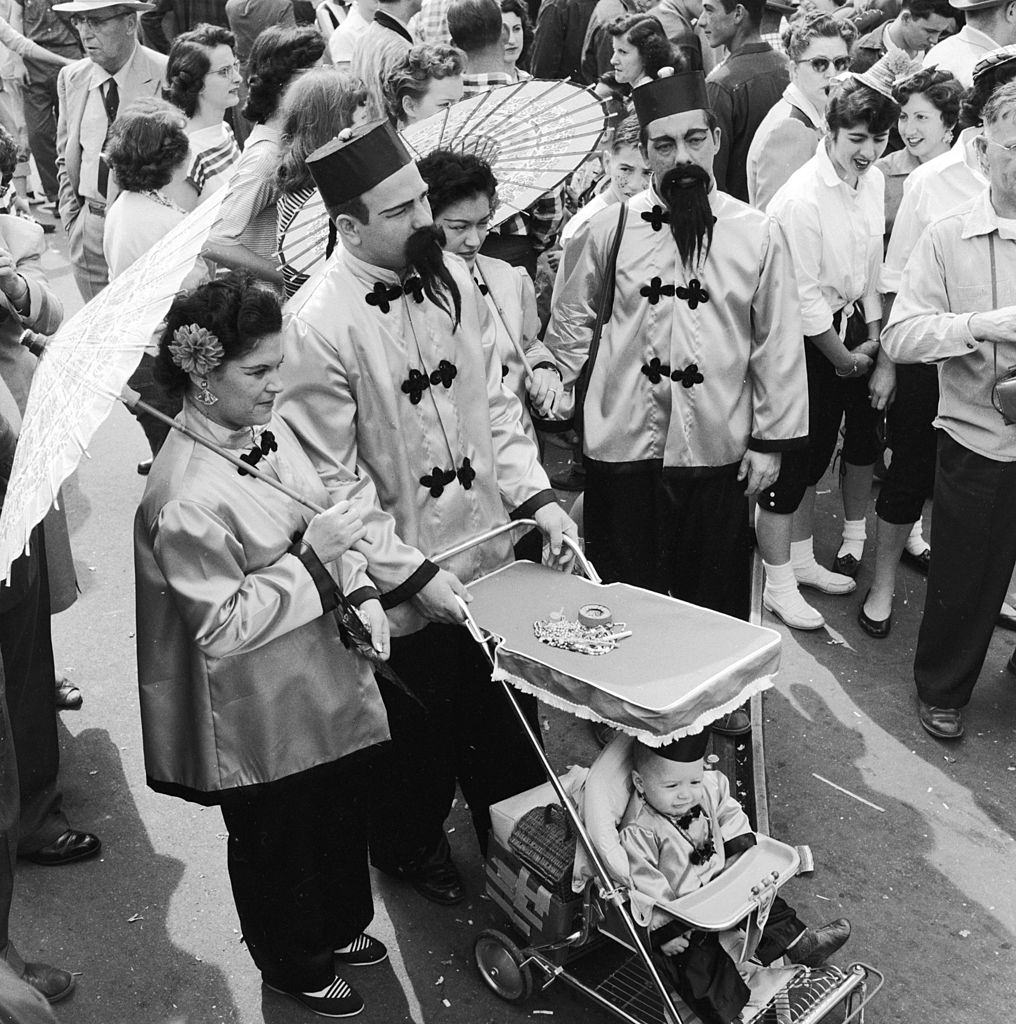 A family in fancy dress dressed identically as Chinese mandarins at the Mardi Gras, in New Orleans, 1956.