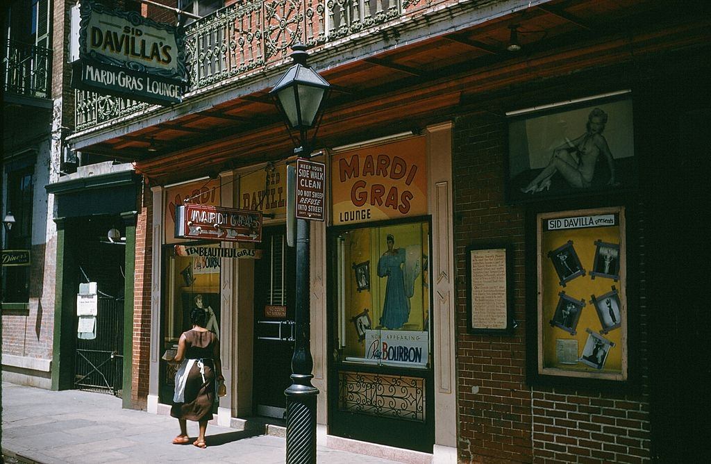 A view down Bourbon street outside Sid Davillas Mardi Gras bar and lounge in New Orleans, 1957.