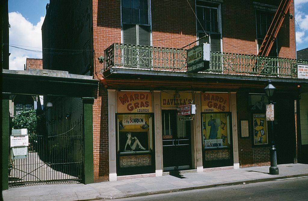 A view down Bourbon street outside Sid Davillas Mardi Gras Longe in New Orleans, 1957.