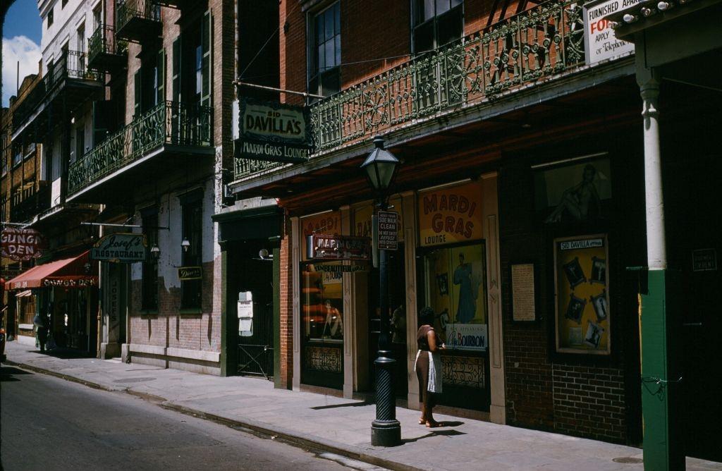 A view down Bourbon street outside Mardi Gras bar and lounge in New Orleans, 1957.
