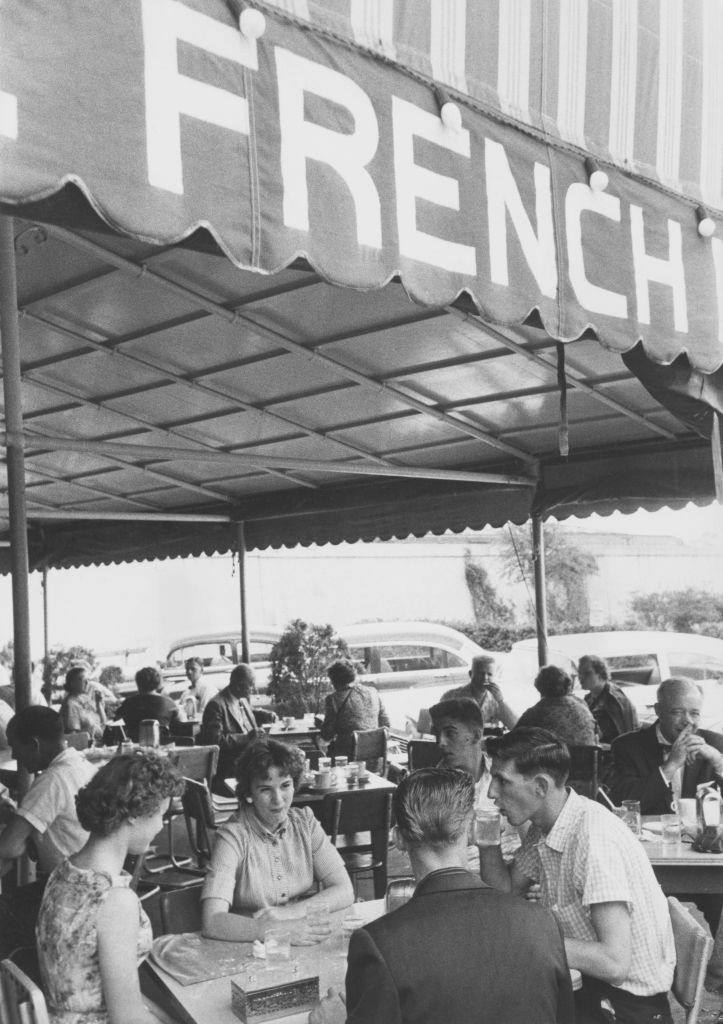 Patrons at the Cafe du Monde, an open-air coffee shop in the French Market, Decatur Street, New Orleans, 1950