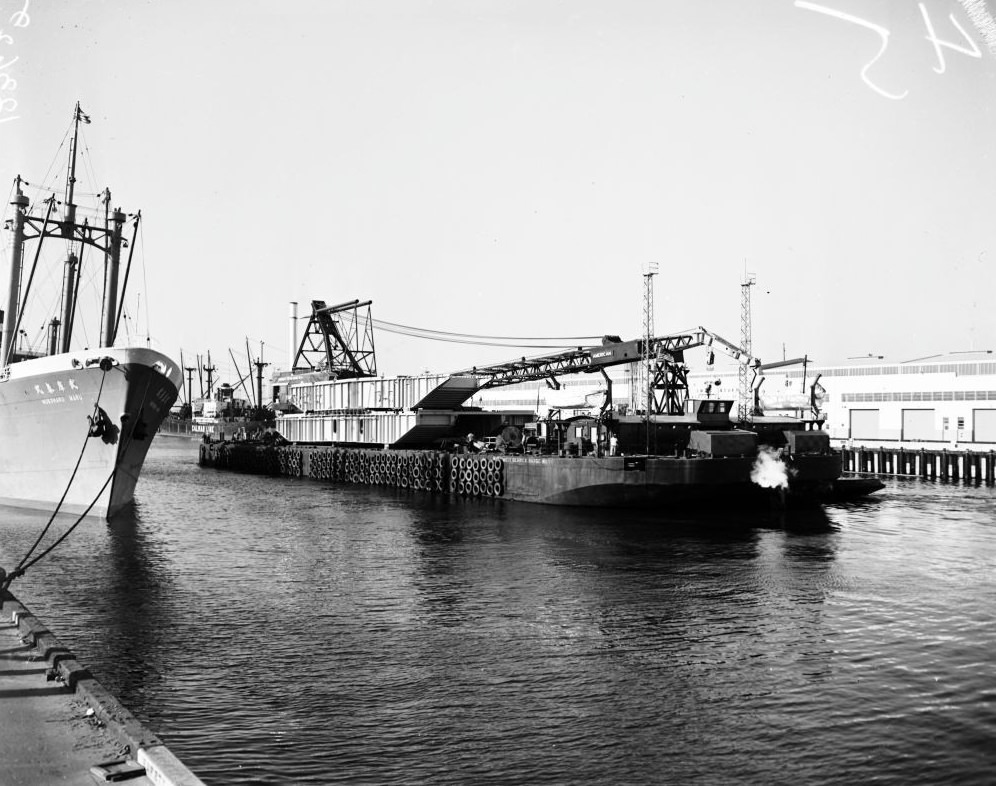 Barge entering Long Beach Harbor to pick up eighty-five feet, 1958