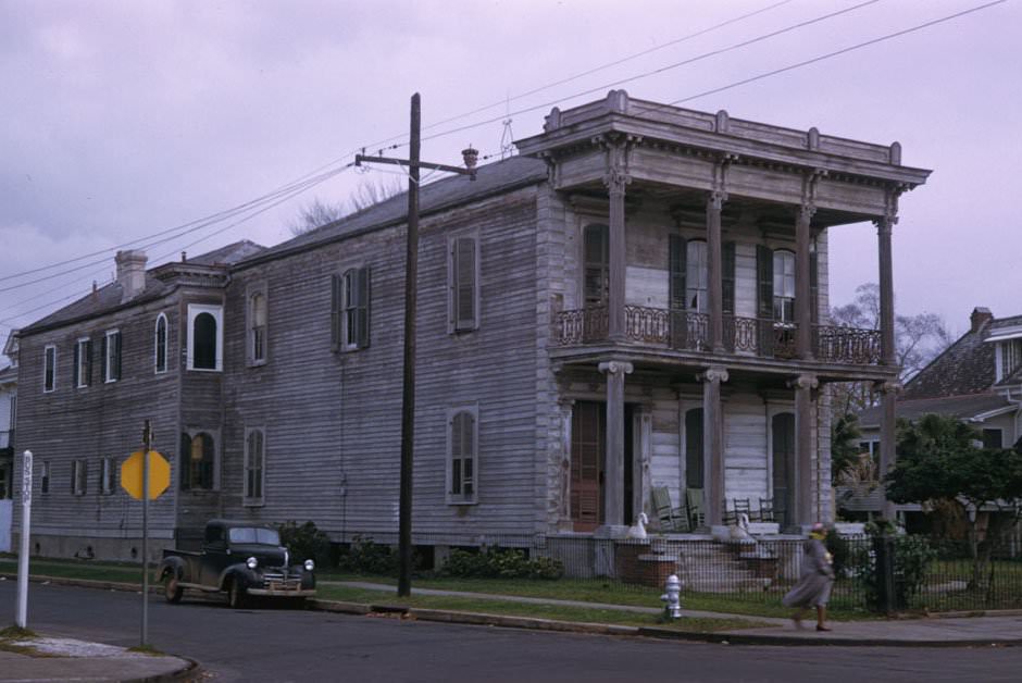 Deep, 2-story frame house unpainted, with high pillars on Esplanade Avenue at Miro Street, New Orleans, 1951.