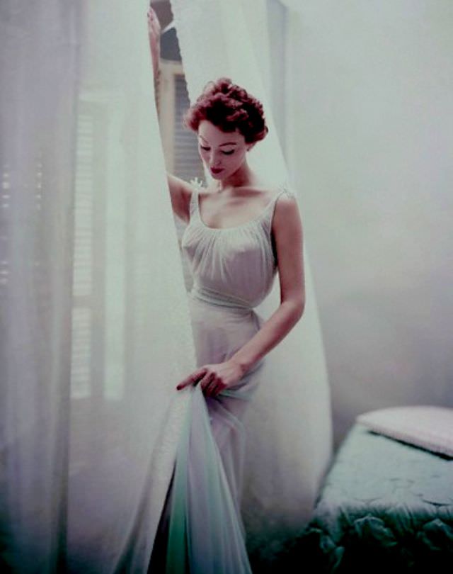 Model is wearing a pale blue chiffon nightgown by Carter's, 1952