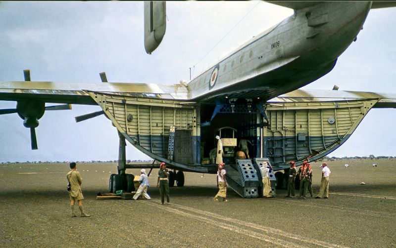 Freight being off loaded from a Beverley heavy transport aircraft operated by the Royal Air force Transport Command at RAF Sharjah in the UAE, 1962